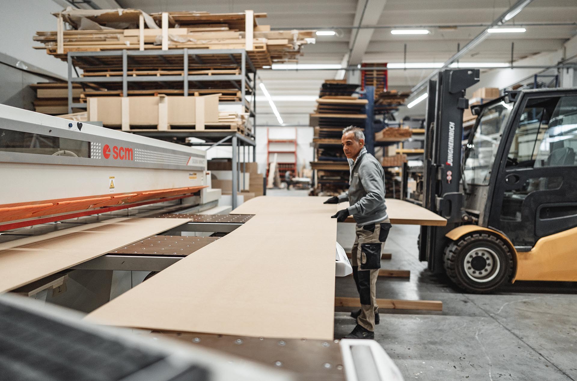 Wooden panels being cut on a panel saw in the factory